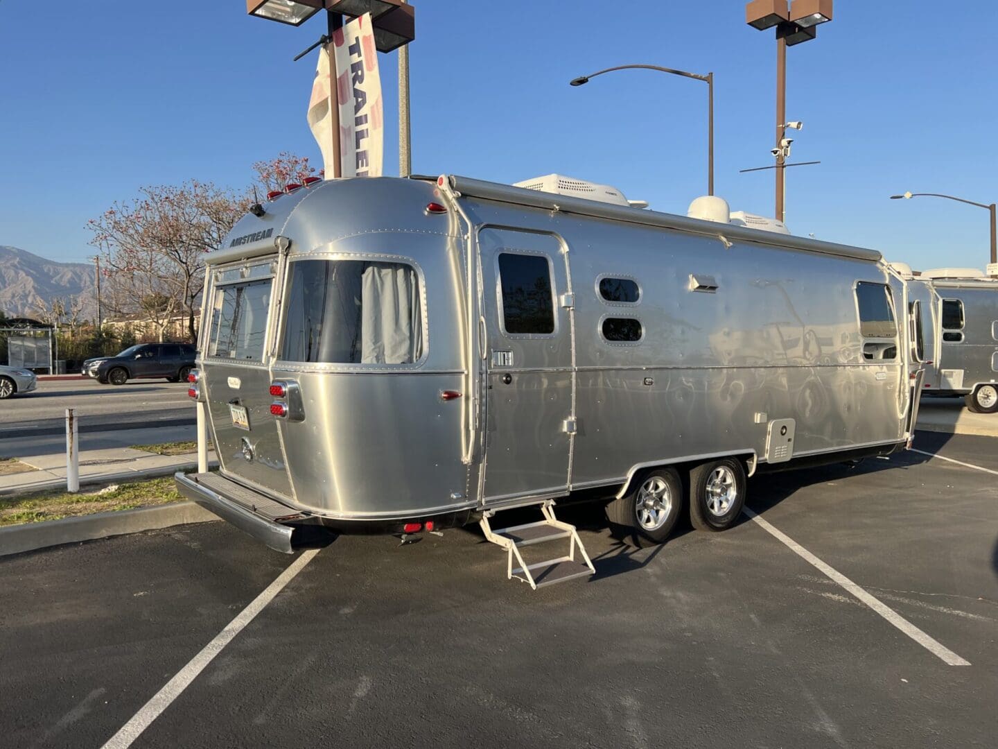 A silver trailer parked in the parking lot.